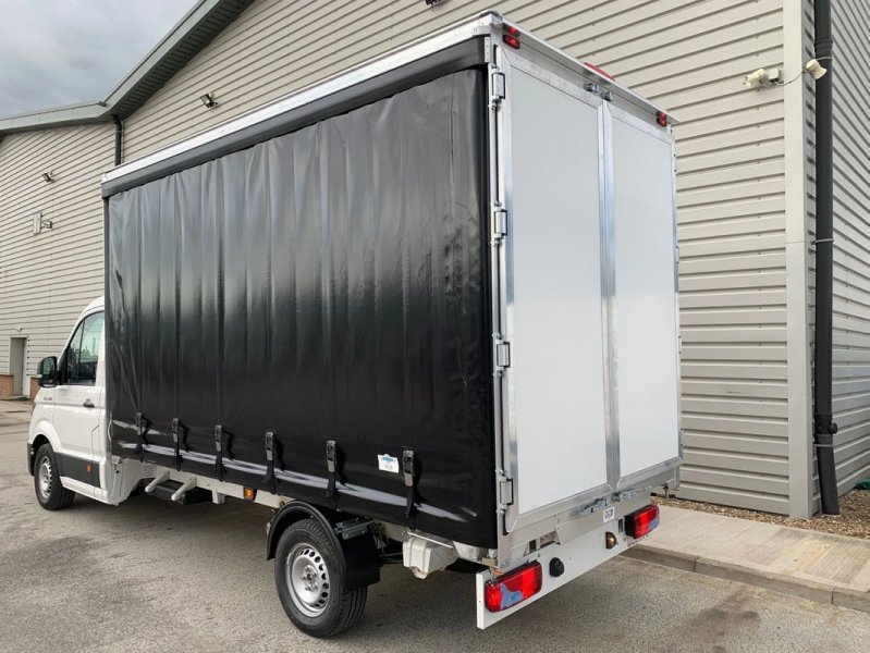 Black curtain sider van on white van