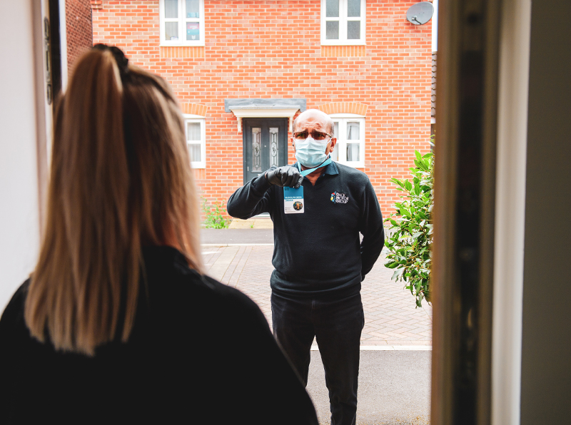 Vehicle Collection man holding ID badge for customer to see, upon home collection.