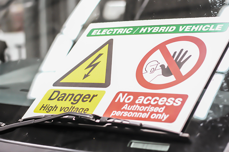 hybrid and electric service - High voltage no access service warning sign placed on the windscreen