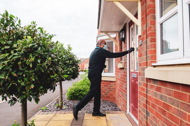 Collection & Delivery Driver knocking on a door at a home collection