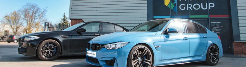 Photo of 2 BMW M Cars outside the front doors of Dack Motor Group in Lincoln
